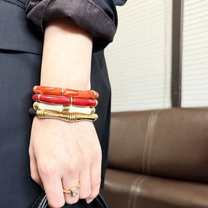 Stacked golden bead elastic bracelets with colorful bamboo tubes and a square zircon ring