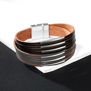 Detail of multi-layer leather bracelet featuring silver metal tubes and magnetic clasp