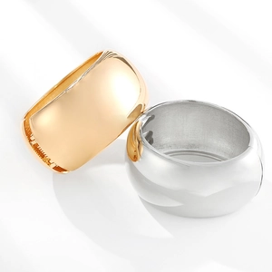 Polished wide gold and silver cuff bracelets with a minimalist curved open design