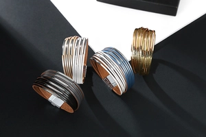 Detail of multilayer leather and metal bracelets with magnetic clasps in four colorways