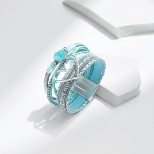 Detail eines mehrlagigen blauen Lederarmbands mit silbernem Herz und Magnetverschluss