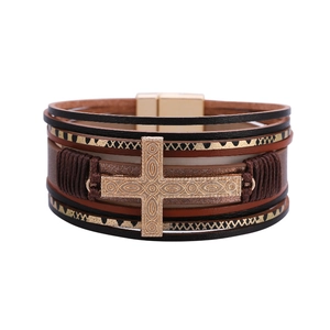 Close-up of multilayer leather bracelet with embossed cross and magnetic metal clasp