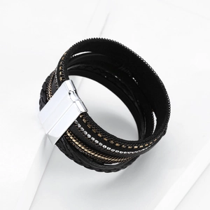 Macro detail of bohemian multilayer leather bracelet with sparkling crystals and magnetic clasp
