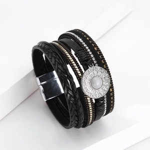 Detail of bohemian multilayer black leather bracelet with crystal pendant and magnetic clasp