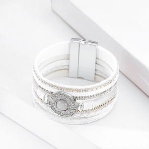 Detail of bohemian multilayer white leather bracelet with crystal rhinestones and cat eye stone