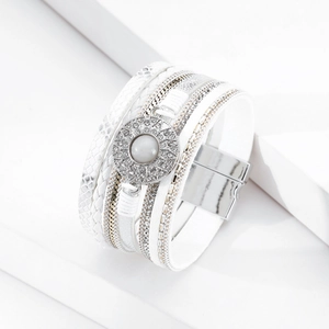 Detail of bohemian multilayer wrap bracelet featuring white faux opal and magnetic clasp