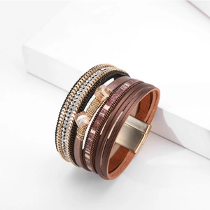 Detailopname van een Boheemse meerlaagse lederen armband met strass en magnetische sluiting