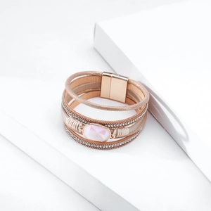 Detail of bohemian multilayer leather bracelet with crystals and gold magnetic clasp
