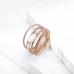 Detail of bohemian layered leather bracelet with rose gold sequins and magnetic clasp