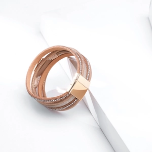 Macro detail of Bohemian multilayer leather bracelet with crystals and rose gold magnetic clasp
