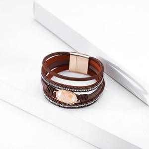 Macro detail of Bohemian multilayer leather bracelet with rhinestones and magnetic clasp