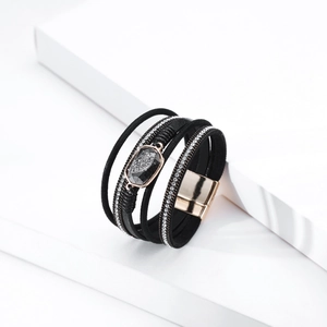Detail of bohemian multilayer leather bracelet with crystal stones and rose gold magnetic clasp
