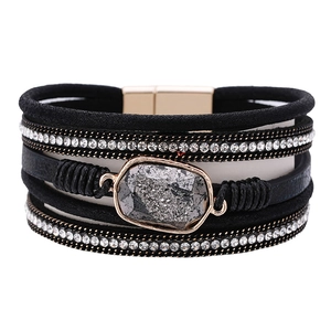 Bohemian multilayer leather bracelet with crystals and grey stone center on white backdrop