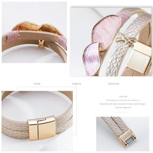 Close-up of pink leaf charms and sparkling X-shaped rhinestones on layered leather bracelet