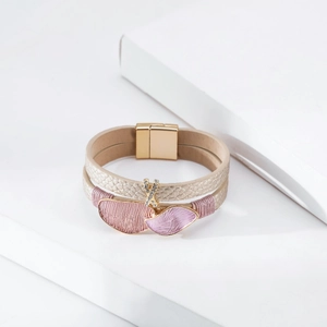Close-up of champagne gold leather wrap bracelet with crystal charms and magnetic clasp