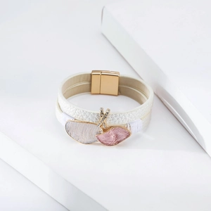 Detail of white leather multi-layer bracelet with gold magnetic clasp and leaf charms