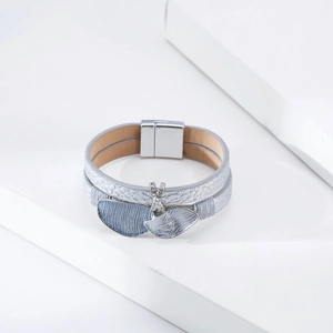 Detail of silver grey double layer leather bracelet with X-shaped rhinestones and magnetic buckle