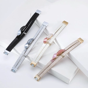 Detail of four-color double-layer leather magnetic bracelets with leaf-shaped metal charms