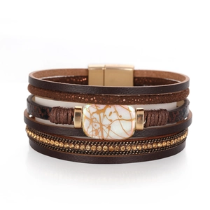 Detail of multilayer leather bracelet with pearl stone and sparkling rhinestone inlay
