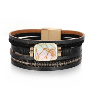 Detail of multilayer leather bracelet with rhinestones and marble stone magnetic clasp