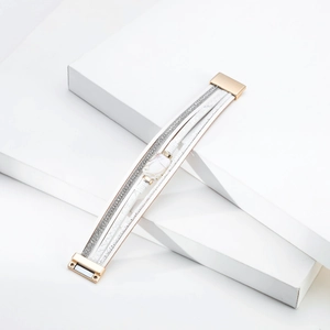 Detail of multi-layered leather bracelet with glitter bands and faux marble stone