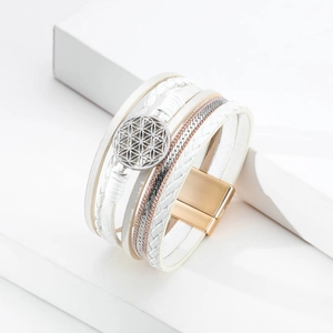 Macro detail of multi-layer leather bracelet with flower of life charm and magnetic buckle
