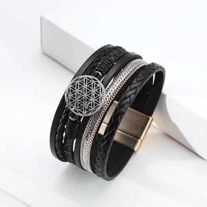 Macro detail of multi-layer leather bracelet with flower of life charm and magnetic clasp