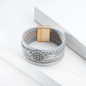 Detail of bohemian multilayer leather bracelet with tree of life charm and magnetic clasp