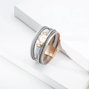 Detail of multi-layer leather bracelet with rhinestone bands and magnetic buckle clasp