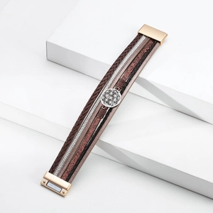 Detail of bohemian multilayer leather bracelet with silver flower disk and magnetic clasp