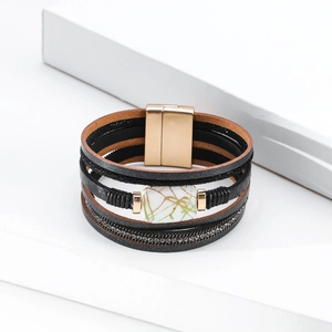 Close-up of multilayer leather bracelet with rhinestones and marble stone magnetic clasp