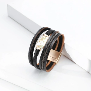 Macro detail of multi-layer leather bracelet with rhinestone inlay and magnetic buckle