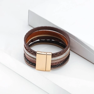Detail of bohemian multilayer leather bracelet with metallic chains and magnetic clasp