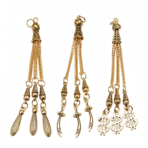Detailed set of three golden alloy tassel pendants with sword and dollar sign motifs