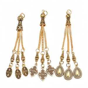 Macro view of vintage alloy tasbih tassel charms with intricate ethnic hollow patterns