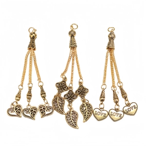 Detail of vintage gold alloy heart and leaf charms for Tasbih prayer bead necklaces