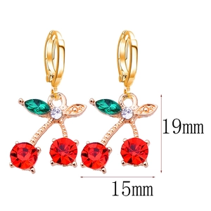 Elegant red crystal cherry drop earrings with green leaves and gold base on white background