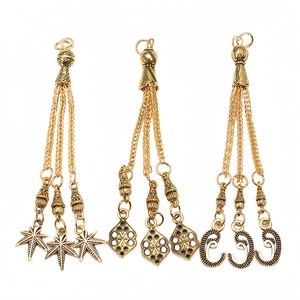 Three vintage gold alloy tassel charms with leaf and geometric dangles for prayer beads