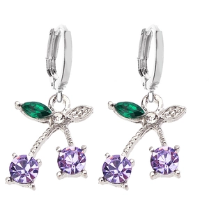 Detailed view of cherry earrings featuring purple gemstones and green zircon leaves