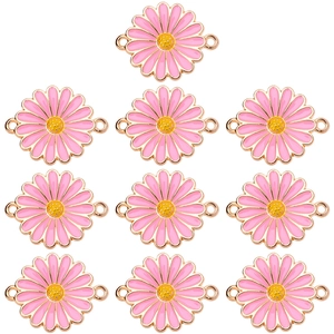 Close-up of 10 pink enamel daisy pendants with gold edges for DIY necklace jewelry making
