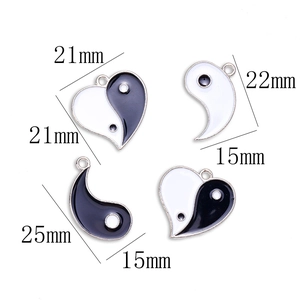 Yin Yang heart pendants set in black and white enamel finish with 21mm dimensions