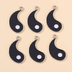 Detailed view of six black enamel yin yang pendant charms for DIY jewelry making