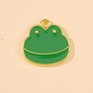 Macro detail of the green enamel frog pendant with polished gold-tone alloy finish