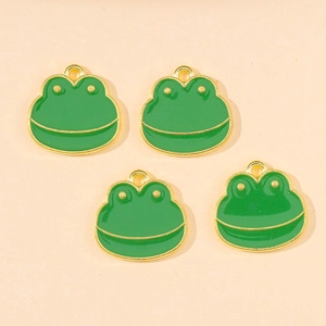 Detailed view of four green enamel frog charms with gold metal frames for DIY jewelry