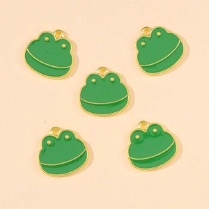 Detailed view of five cartoon green enamel frog charms with gold metal plating for DIY jewelry