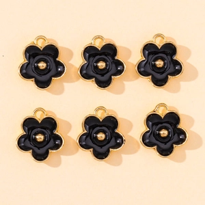 Détail de six pendentifs fleurs en émail noir et plaqué or pour la création de bijoux DIY