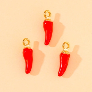 Close-up of three bright red chili pepper charms with golden loops for DIY jewelry