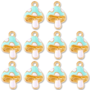 Close-up of 10 mint green enamel mushroom pendants with gold metal edges for DIY jewelry
