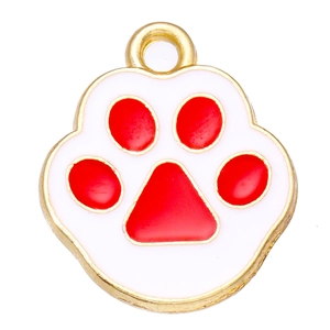 Macro shot of white and red enamel cat paw pendant with golden metal edges for DIY jewelry