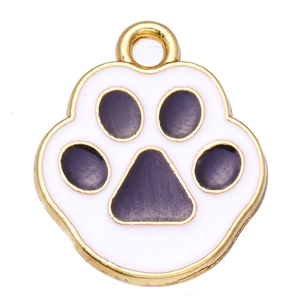 Detailed macro view of a golden alloy cat paw pendant with purple enamel and hanging hole